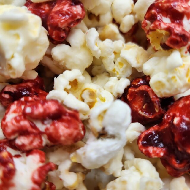 Strawberry cheesecake frozen popcorn with red strawberry kernels and white cheesecake Kernelz